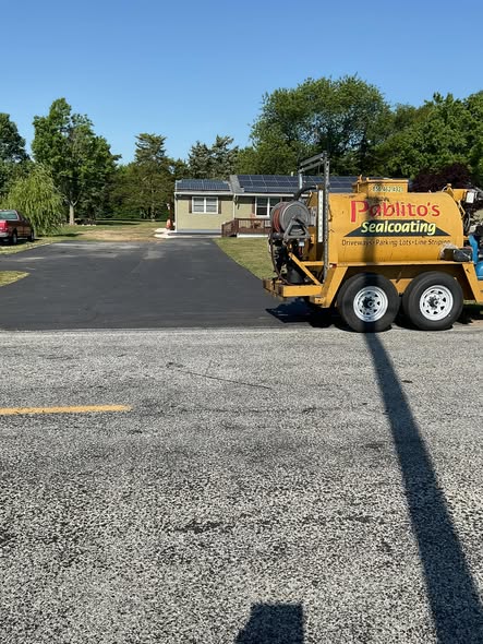Sealcoating equipment on asphalt jobsite